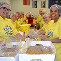 Volunteers smiling and wearing hair nets while at United Way of Berks County Big Chees 5 event