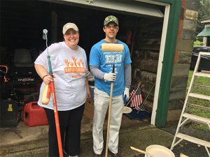 United Way of Berks County volunteers holding paint rollers