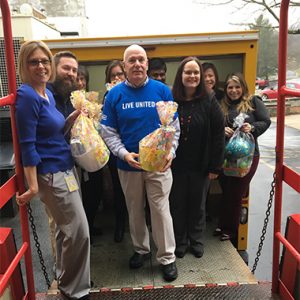 Penske volunteers in group to distribute Easter baskets