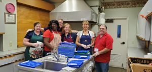 Loaned Campaign Specialists and Shelley Shaffer preparing food at New Journey Community Outreach