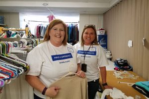 Volunteers sorting clothes on Day of caring at New Journey Community Outreach