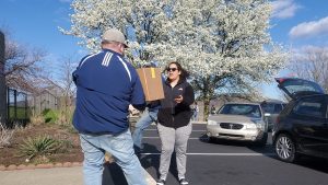 Woman receiving food items at Olivet Boys and Girls Club