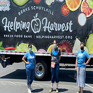 Emerging Leaders United posing in front of Helping Harvest truck