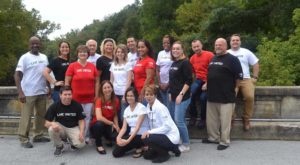 United Way of Berks County, group of individuals form diverse groups standing on a bridge