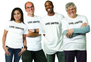 a group of adults of various ages wearing Live United t-shirts