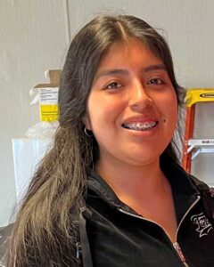 A teen is smiling at the camera