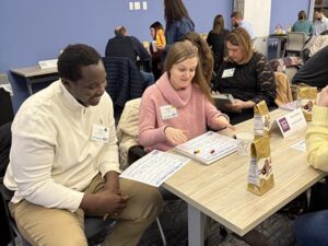 A man and woman are sitting at a table looking at papers