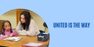 A teenage girl is helping an elementary-aged girl with reading