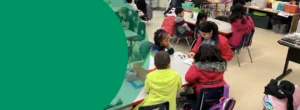 Children in an elementary school classroom are doing school work in groups