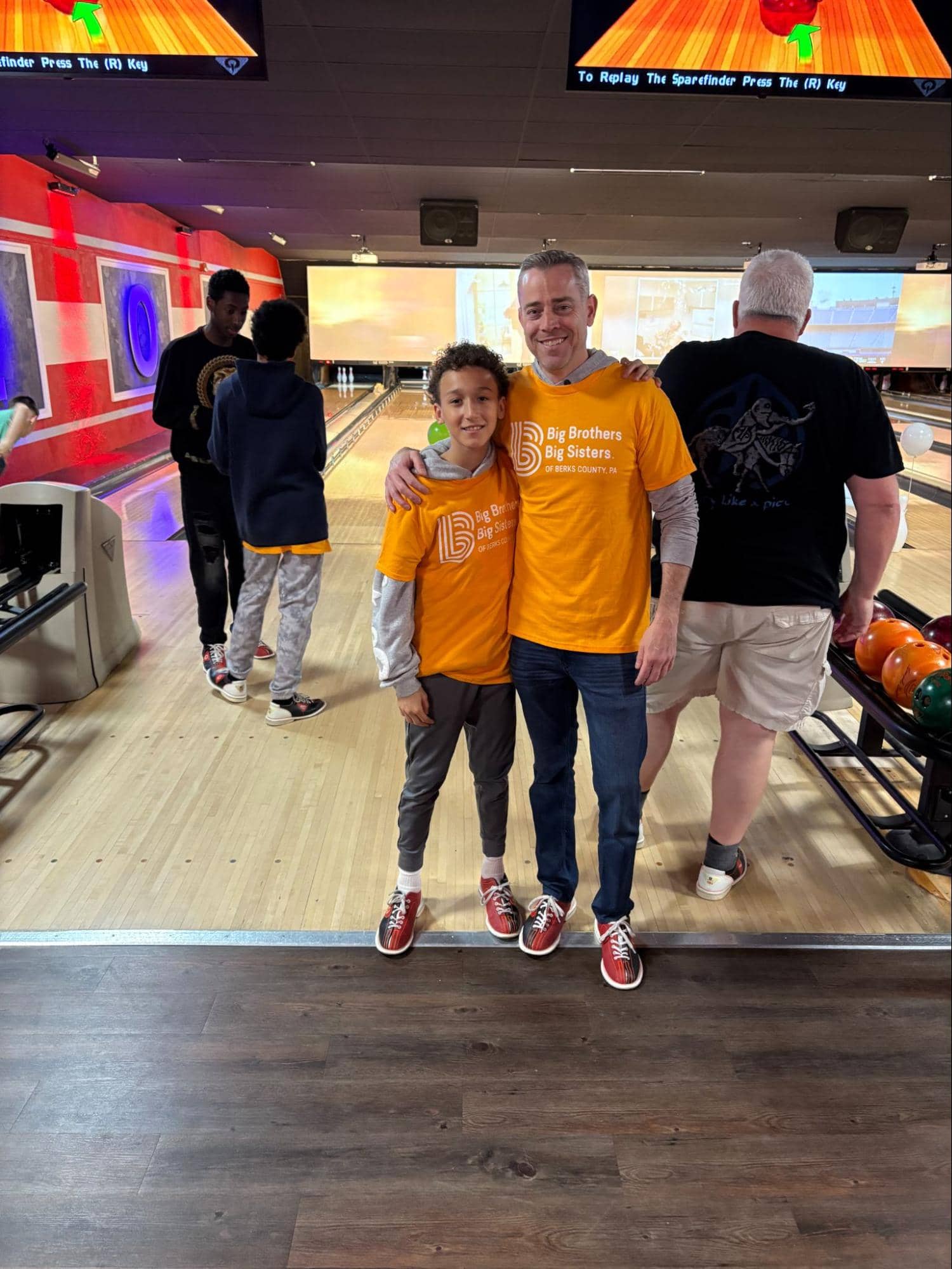 Greg and his little brother Jacob wearing matching orange shirts at a Big Brothers Big Sisters of Berks County PA bowling event.